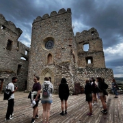 People standing outside of a historic castle